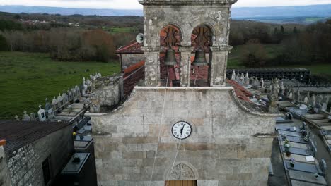 Drone-descend-to-establish-San-Martino-de-Betan-church-with-chains-leading-to-bells
