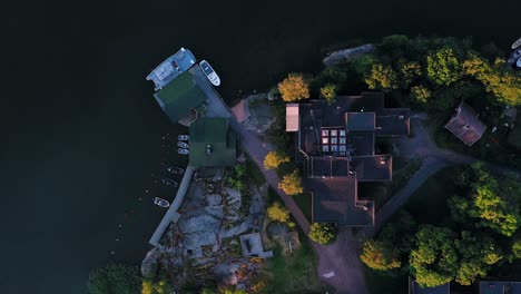 Aerial-view-over-the-Tvarminne-zoological-station,-during-summer-sunset,-in-Hanko,-Finland---Tracking,-top-down,-drone-shot