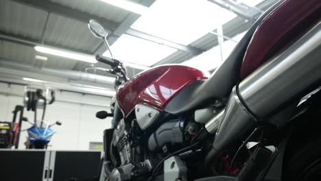Low-Angle-View-Of-Stationary-Motorbike-Inside-Workshop