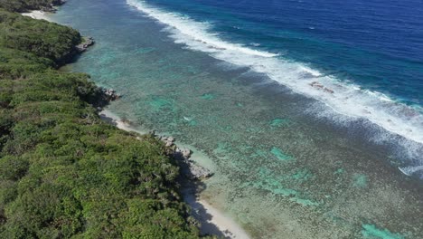 Drone-Shot-of-Protected-Coral-Reefs-Between-South-Pacific-Ocean-Waves-and-Tropical-Island-of-Tonga,-Polynesia