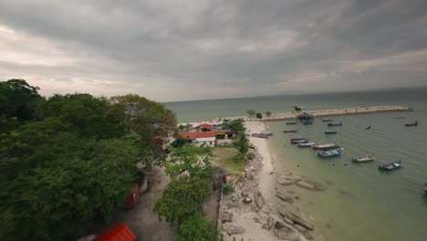 Captivating-FPV-aerial-footage-showcases-the-traditional-boats,-local-architecture,-and-the-vibrant-coastal-environment