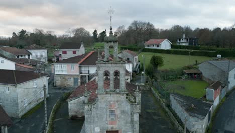 Aerial-pullback-establish-of-old-weathered-broken-down-church-in-Banos-de-Molgas