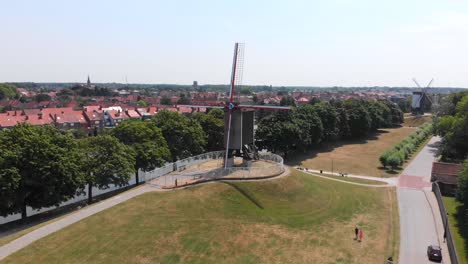 Ascending-Aerial-Orbit-around-Tradition-Windmill-in-Bruges,-Belgium