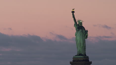 Statue-of-Liberty-on-Pedestal-at-Sunset,-Pink-Sky