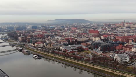 Historic-old-town-in-Krakow-by-Vistula-River-aerial-panorama-in-misty-morning