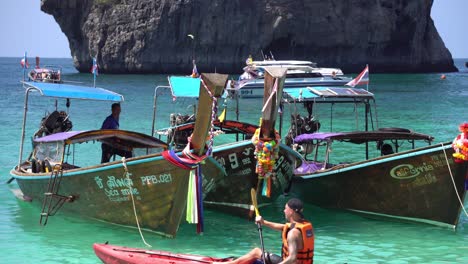 Colorful-Thai-Boats-Anchored-on-Exotic-Tropical-Beach-in-Krabi-Province,-Thailand