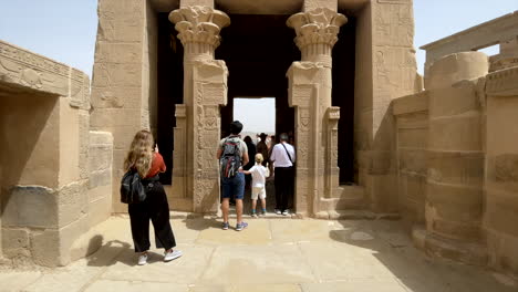 TOURISTS-VIST-RELIGIOUS-TEMPLE-OF-HATHOR-INSIDE-ISIS-TEMPLE-IN-PHILAE,-EGYPT
