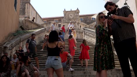 Mass-of-tourists-on-stairs-of-Jesuit,-camera-tilting-down-view