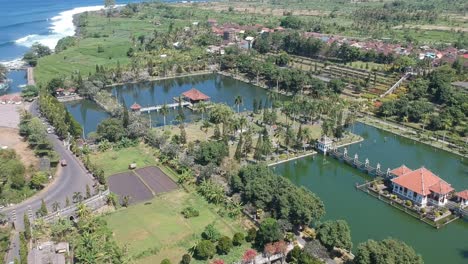 Aerial-Pan-Down-To-Reveal-Bali-Temples-Surrounded-By-Moats,-Indonesia