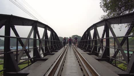 Tourists-Walking-Over-River-Kwai-Bridge,-Thailand