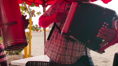 A-man-is-playing-the-accordion-while-another-is-playing-the-Guacharaca