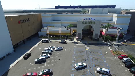 Slow-motion-aerial-drone-panning-shot-over-parking-lot-of-South-Bay-Galleria-shopping-mall-by-Hawthorne-Blvd,-and-Artesia-Blvd