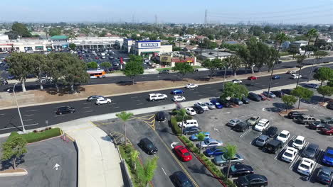 Aerial-drone-flying-away-from-South-Bay-Galleria-shopping-mall-over-the-parking-lot-by-Hawthorne-Blvd-and-Artesia-Blvd