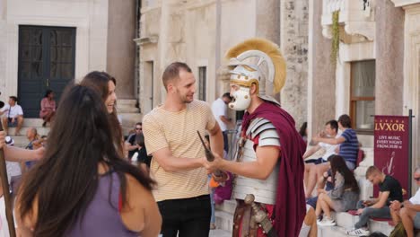 Roman-warrior-pose-with-tourists