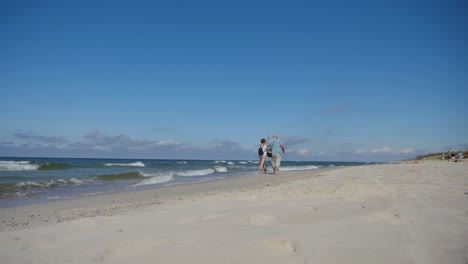Loving-elder-couple-walking-on-the-coastline-of-the-Baltic-sea-and-enjoying-the-moment-together-in-slow-motion-shot