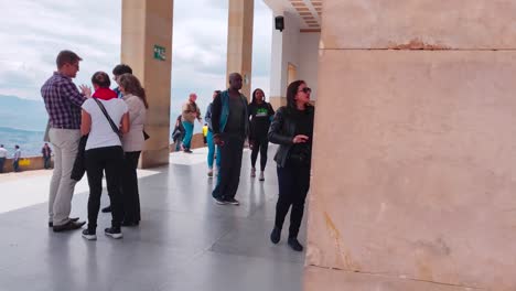 Tourists-walking-close-to-the-entrance-of-a-church-on-top-of-Monserrate-cable-car-in-Bogotá,-Colombia