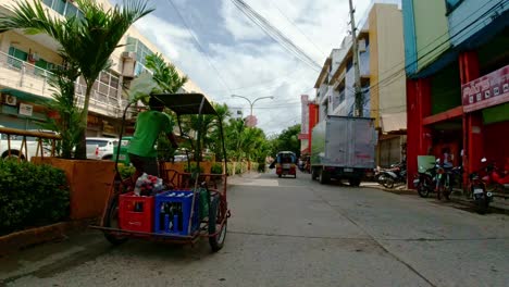 A-tricyclist-rides-local-tricycle-loaded-with-soft-drinks-through-the-streets