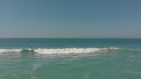 Luftaufnahme-Eines-Surfers,-Der-Auf-Einer-Welle-Reitet,-Bis-Er-Am-Praia-Do-Santinho,-Brasilien,-Herunterfällt-–-4k,-24-Fps