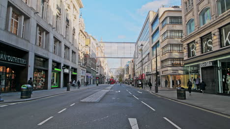 London-in-Covid-19-Coronavirus-lockdown-with-quiet-empty-roads-at-Oxford-Street-with-closed-shops-shut-at-the-popular-shopping-high-street-in-the-pandemic-in-England,-Europe