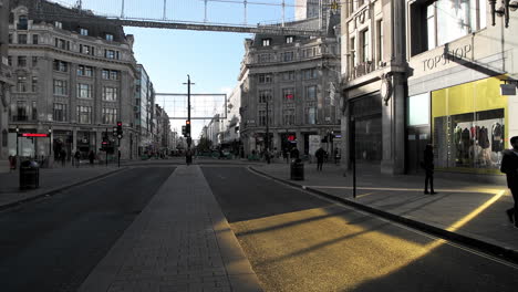 London-in-Covid-19-Coronavirus-lockdown-with-quiet-empty-roads-at-Oxford-Street-and-Oxford-Circus,-with-closed-shops-shut-down-at-the-popular-shopping-high-street-in-the-pandemic-in-England,-Europe