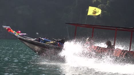 Slow-Motion-of-Thai-Long-Tail-Boat-Sailing-in-Tropical-Sea-Water-by-Steep-Cliffs-of-Phi-Phi-Islands,-Thailand,-Cinematic-POV