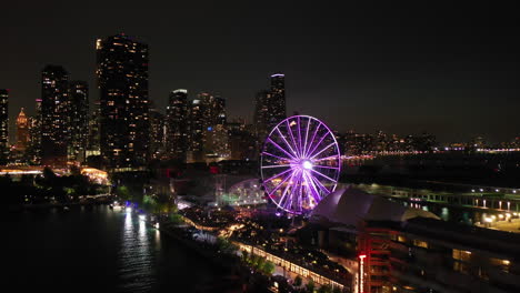 Aerial-view-over-the-illuminated-Centennial-Wheel,-night-at-the-Navy-Pier-in-Chicago,-USA