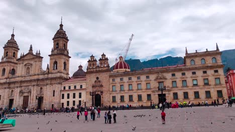 Tourists-and-local-people-walking-in-a-Plaza-of-the-Historic-Center-of-Bogotá,-Colombia