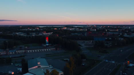 Aerial-view-of-the-city-of-Vaasa,-sunset-in-Ostrobothnia---reverse,-drone-shot