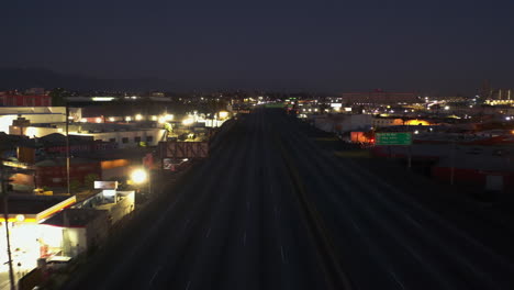 Aerial-view-flying-over-the-I-10,-damaged-after-a-fire,-night-in-Los-Angeles