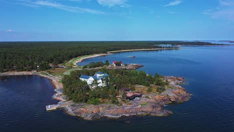 Aerial-View-of-Traditional-Holiday-Villa-on-Finnish-Coast-with-Summer-Blue-Sky