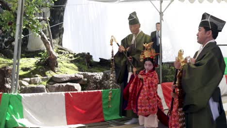 A-Japanese-monk-walking-with-two-geisha-child-at-a-commemoration-ceremony-in-Kyoto