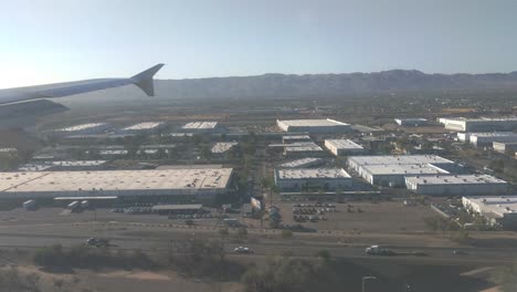View-through-window-of-commercial-airliner-landing-at-Phoenix-airport
