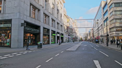 London-in-Covid-19-Coronavirus-lockdown,-with-quiet-roads-at-Oxford-Street-with-closed-shops-shut-at-the-popular-shopping-high-street-in-the-pandemic-in-England,-Europe