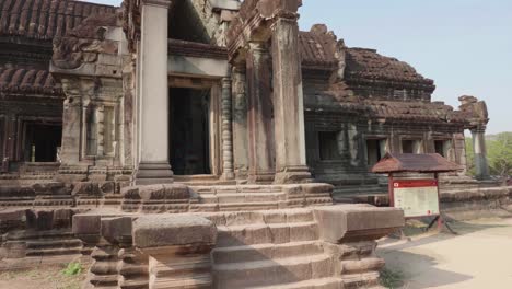 Walking-Past-An-Entrance-Of-A-Building-While-Recording-Towards-The-Entrance,-In-The-Courtyard-Of-Angkor-Wat