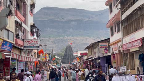 Locals-In-A-Busy-Street-In-Town-Of-Trimbak-With-View-Of-Trimbakeshwar-Shiva-Temple-In-Distant-Background-At-Daytime
