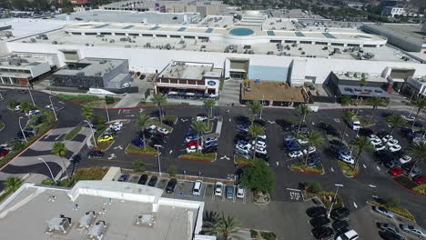 Aerial-Drone-flying-across-Del-Amo-Fashion-Center-parking-lot-and-shops-with-one-under-construction