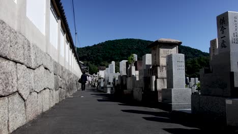 People-walking-on-the-street-next-to-the-biggest-cemetery-in-Kyoto