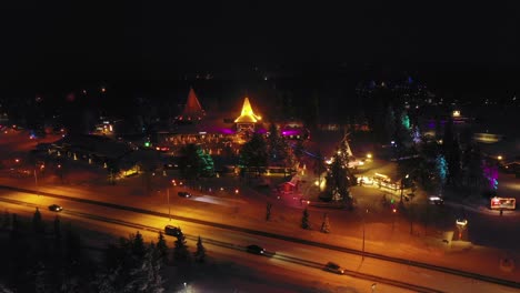 Luftdrohnenaufnahme-In-Richtung-Des-Weihnachtsmanndorfes,-Winterabend,-In-Rovaniemi,-Finnland