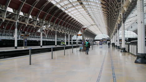 One-person-walking-in-Paddington-Train-Station-empty-during-Coronavirus-Covid-19-lockdown-in-London-when-public-transport-was-quiet-and-deserted-with-no-people-in-England,-Europe