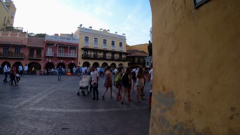 A-group-of-women,-tourists,-is-walking-down-a-plaza-of-the-old-town-of-Cartagena-de-Indias,-Colombia