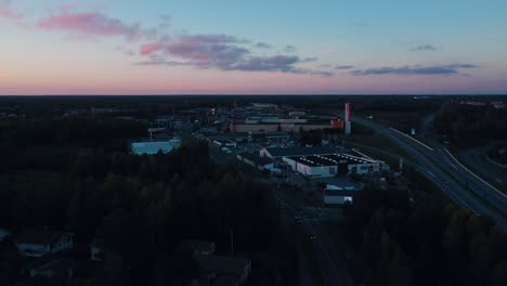 Aerial-drone-view-towards-a-industrial-area-in-Vaasa,-summer-sunset-in-Finland