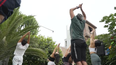 Group-Of-People-Posing-In-Home's-Yard-Breathing-And-Stretching,-Lima,-Peru
