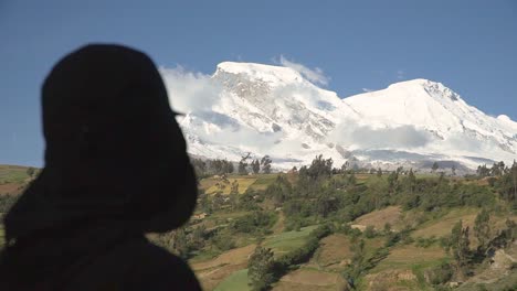 Man-silhouette-watching-over-the-mountain-snow-landscape,-Peru,-Huaraz,-Yungay