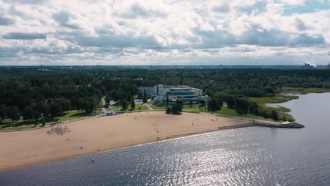 Aerial-view-around-the-Eden-spa-and-resort,-in-sunny-Nallikari,-Oulu,-Finland---orbit,-drone-shot