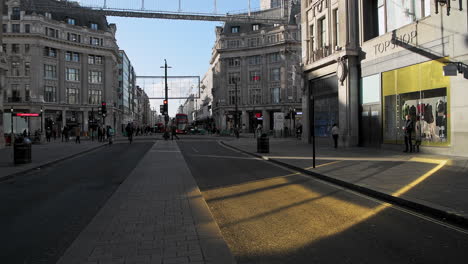 London-in-Covid-19-Coronavirus-lockdown-with-quiet-empty-roads-at-Oxford-Street-and-Oxford-Circus,-with-closed-shops-shut-down-at-the-popular-shopping-high-street-in-the-pandemic-in-England,-Europe