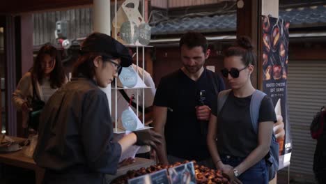 European-tourists-buying-chestnuts-in-Kyoto-Japan