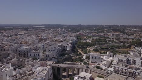 Drone-Shot-of-Polignano-a-Mare-from-the-coast-to-the-old-town