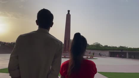 Gente-Admirando-El-Stambh-Que-Alberga-La-Llama-Inmortal-En-El-Monumento-Nacional-A-La-Guerra-En-Nueva-Delhi,-India
