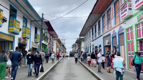 Tourists-and-residents-walking-in-the-colonial-architecture-downtown-of-Filandia-Qundio-Colombia,-on-the-heart-of-the-coffee-zone