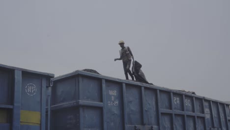 Coal-Industry-Worker-Walking-On-Top-Of-Iron-Ore-Loaded-In-Delivery-Wagon